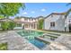 Back of house featuring luxurious pool and spa and covered patio area at 1630 Lasbury Ave, Winter Park, FL 32789