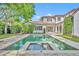 Inviting pool with a spa, stone surround, and the home's architecture in the background at 1630 Lasbury Ave, Winter Park, FL 32789