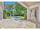 Relaxing pool and patio area surrounded by lush landscaping and privacy hedges at 1630 Lasbury Ave, Winter Park, FL 32789