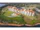 Aerial view of lakefront condo buildings featuring a swimming pool and lush landscaping at 16300 County Road 455 # 704, Montverde, FL 34756