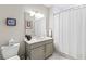 Bathroom featuring a grey vanity, modern lighting, and a shower with curtain at 16300 County Road 455 # 704, Montverde, FL 34756