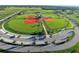 Aerial view of community baseball complex with green lawns, dugouts, sports fields and parking at 1647 Redfin Dr, Kissimmee, FL 34759