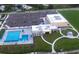 Aerial view of community pool, clubhouse, parking, and green space in a park-like setting at 1647 Redfin Dr, Kissimmee, FL 34759