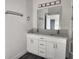 Dual sink bathroom vanity with white cabinets and modern lighting at 1647 Redfin Dr, Kissimmee, FL 34759