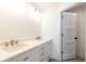 Bathroom with double sinks, white cabinets, and neutral walls at 1806 Dixie Belle Dr, Orlando, FL 32812