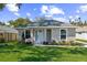 Charming home featuring a gray exterior, well-manicured lawn, and fresh landscaping at 1806 Dixie Belle Dr, Orlando, FL 32812