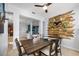 Bright dining area with wooden table, chairs, and a unique wooden plank accent wall with plants at 1810 Trophy Bass Way, Kissimmee, FL 34746