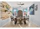 Elegant dining room featuring a wooden plank accent wall, stylish light fixture, and tile flooring at 1810 Trophy Bass Way, Kissimmee, FL 34746