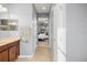 Hallway view leading to a well-lit bedroom, showcasing a seamless transition and bright atmosphere at 1810 Trophy Bass Way, Kissimmee, FL 34746