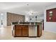 Modern kitchen island features granite countertops, stainless steel appliances, and stone-accent wall at 1810 Trophy Bass Way, Kissimmee, FL 34746