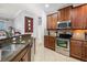 Open-concept kitchen featuring stainless steel appliances and granite countertops with an adjacent breakfast bar at 1810 Trophy Bass Way, Kissimmee, FL 34746