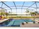 Inviting screened-in pool with beautiful lake views and well-manicured landscaping at 1810 Trophy Bass Way, Kissimmee, FL 34746