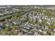 Aerial view of the residential neighborhood showcasing the layout of streets, homes, trees and green spaces at 202 Longview Ave, Kissimmee, FL 34747