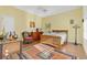 Cozy bedroom with hardwood floors, a ceiling fan, and sunlit windows at 202 Longview Ave, Kissimmee, FL 34747