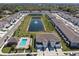 Aerial view of a townhome community featuring a pool, pond with fountain, landscaping, and neatly arranged residential buildings at 2037 Canny Cv, Winter Park, FL 32792