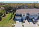 Aerial view of townhome featuring two-car garage, modern exterior, and well-maintained landscaping in a community setting at 2037 Canny Cv, Winter Park, FL 32792