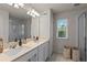 Bright bathroom with a double sink vanity, shower, and natural light at 2037 Canny Cv, Winter Park, FL 32792