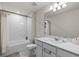 Bright bathroom with white tile shower, toilet, vanity and sink at 2037 Canny Cv, Winter Park, FL 32792