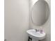 A pedestal sink and an oval mirror in a half bathroom at 2037 Canny Cv, Winter Park, FL 32792