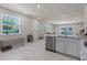 Well-lit kitchen area with stainless steel dishwasher and view into the living area at 2037 Canny Cv, Winter Park, FL 32792