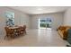 Bright living room with dining area and sliding glass door to the outdoors at 2037 Canny Cv, Winter Park, FL 32792