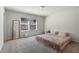 Carpeted main bedroom featuring a full-length mirror and sun-filled windows at 2037 Canny Cv, Winter Park, FL 32792