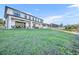 Large, grassy backyard leading to a covered patio with outdoor seating and dining areas at 2072 Starboard Dr, Geneva, FL 32732