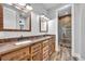 This bathroom features wood cabinets, double sinks, modern light fixtures, and a glass walk-in shower at 2072 Starboard Dr, Geneva, FL 32732