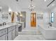 Bright and modern bathroom with dual vanities, a freestanding tub, and a chandelier at 2072 Starboard Dr, Geneva, FL 32732