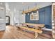 Rustic dining room featuring a large wooden table, matching benches, and a unique lighting fixture at 2072 Starboard Dr, Geneva, FL 32732