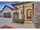 Elegant home entrance with stone pillars, decorative glass door, and lush landscaping at 2072 Starboard Dr, Geneva, FL 32732