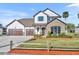 Charming two-story home featuring stone accents, manicured lawn, and three-car garage at 2072 Starboard Dr, Geneva, FL 32732