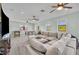 Spacious game room features a large sectional sofa, multiple windows, and several ceiling fans for optimal comfort at 2072 Starboard Dr, Geneva, FL 32732