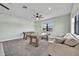 A foosball and air hockey table are bathed in natural light in this carpeted game room at 2072 Starboard Dr, Geneva, FL 32732