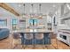 Spacious kitchen features a large island with seating, custom cabinetry, stainless steel appliances, and hardwood floors at 2072 Starboard Dr, Geneva, FL 32732