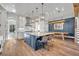 Modern kitchen features an expansive island, stainless steel appliances, and hardwood floors, ideal for entertaining at 2072 Starboard Dr, Geneva, FL 32732