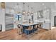 Bright, modern kitchen features a large central island with seating, pendant lighting, and stainless steel appliances at 2072 Starboard Dr, Geneva, FL 32732