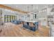 Open-concept kitchen with a large island, seating, and hardwood floors, seamlessly flowing into the living area at 2072 Starboard Dr, Geneva, FL 32732