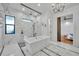 Main bathroom featuring marble tile, free-standing tub, glass shower, and decorative chandelier at 2072 Starboard Dr, Geneva, FL 32732