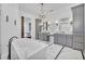 Elegant bathroom featuring granite vanity tops, double sinks, and a free standing soaking tub at 2072 Starboard Dr, Geneva, FL 32732