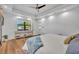 Bright main bedroom featuring a tray ceiling and a window overlooking the neighborhood at 2072 Starboard Dr, Geneva, FL 32732