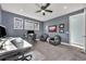 Home office featuring grey walls, carpeted floors, two desks, chairs, windows, and a ceiling fan at 2072 Starboard Dr, Geneva, FL 32732