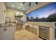 Beautiful outdoor kitchen featuring stainless steel grill, beverage center, sink, and granite countertops at 2072 Starboard Dr, Geneva, FL 32732