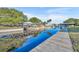 Beautiful waterfront view featuring a private dock, boat lifts, and lush landscaping on a sunny day at 2072 Starboard Dr, Geneva, FL 32732