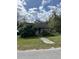 Charming home featuring a walkway, lush greenery, and an inviting atmosphere, perfect for serene living at 218 Franklin St, Ocoee, FL 34761