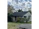Exterior of a cozy residence boasting a classic design, complemented by the surrounding natural landscape and sky at 218 Franklin St, Ocoee, FL 34761