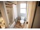 Bathroom with a tiled shower-tub, white toilet, and a view of the vanity at 2211 Oberlin Ave, Orlando, FL 32804