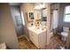 Bathroom featuring a tiled floor, a white vanity, a framed mirror, and a shower with a curtain at 2211 Oberlin Ave, Orlando, FL 32804