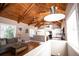 Open living room features a wood beamed ceiling, lots of natural light, and is open to the kitchen at 2211 Oberlin Ave, Orlando, FL 32804