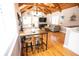 Open living room features a wood beamed ceiling, lots of natural light, and a dining area with seating at 2211 Oberlin Ave, Orlando, FL 32804